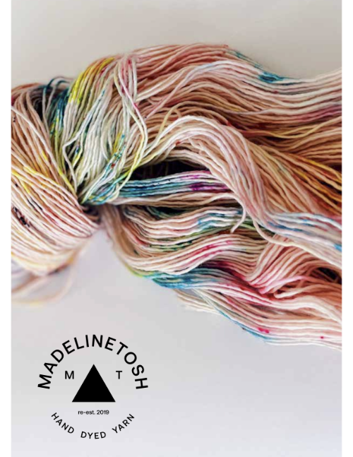 Colorful yarn skein with Madelinetosh logo on a white background
